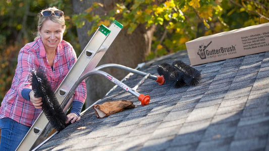 ladder stabilizer and smiling woman installing diy brush gutter guard